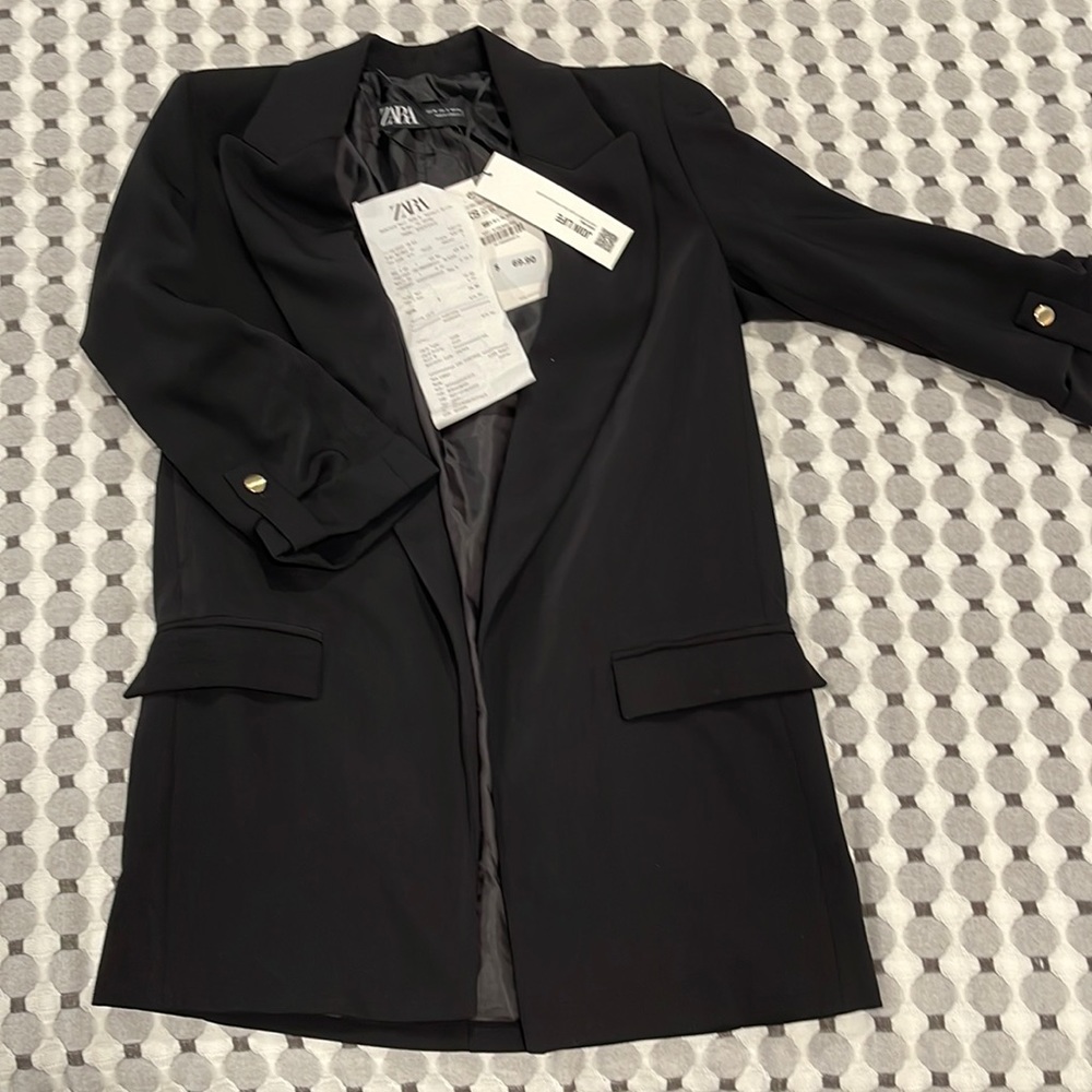 Black blazer with small shoulder pads.